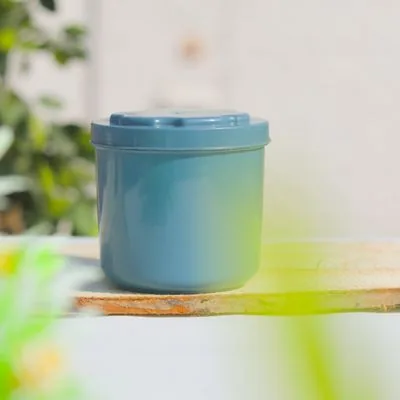Opaque blue cylindrical plastic container with matching lid