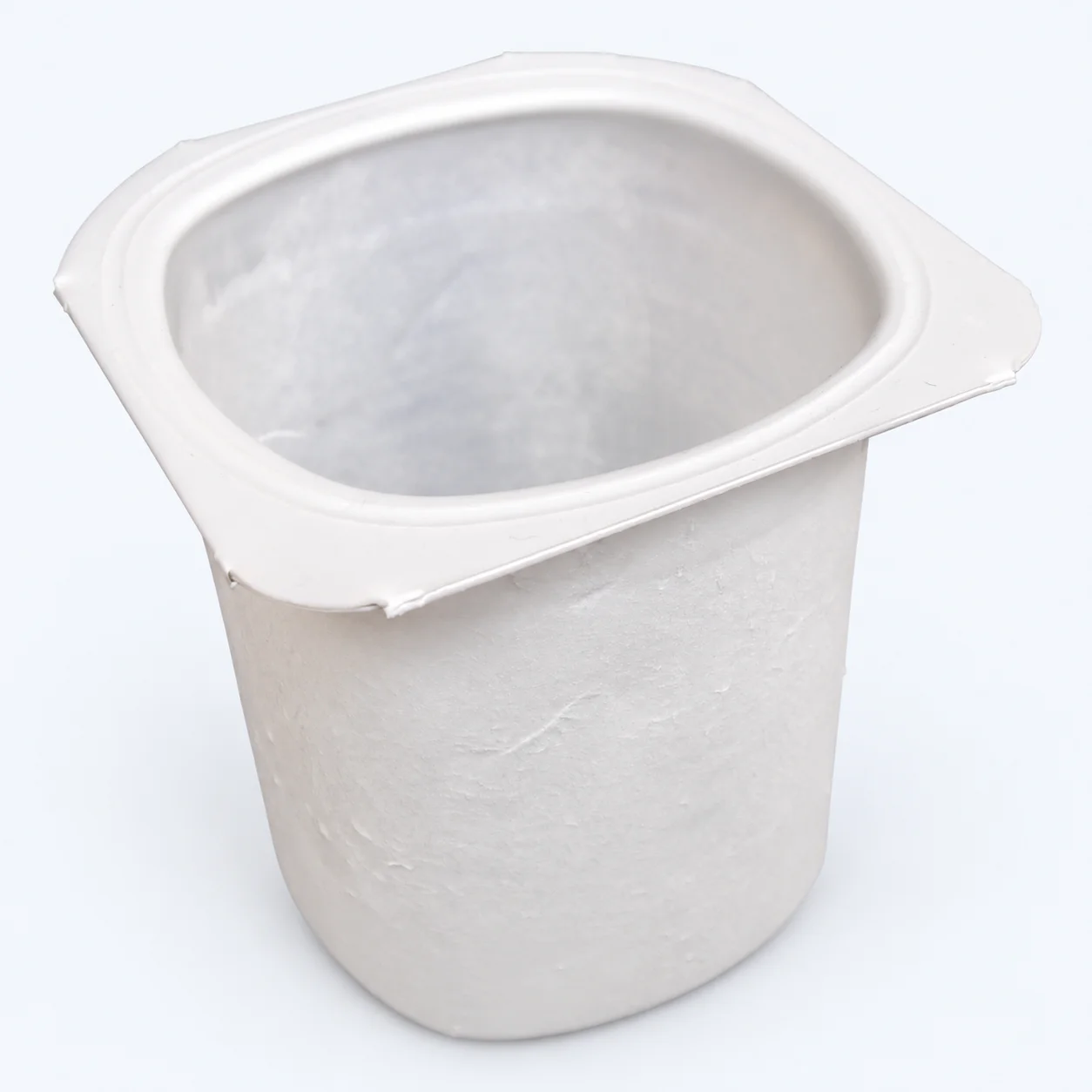 Empty plastic yogurt tub — third-party photographic reference
