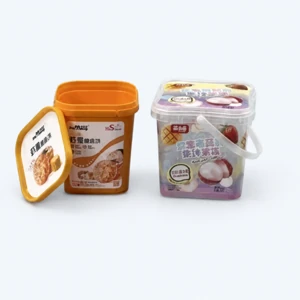 Two decorated square plastic pails with lids and a carrying handle