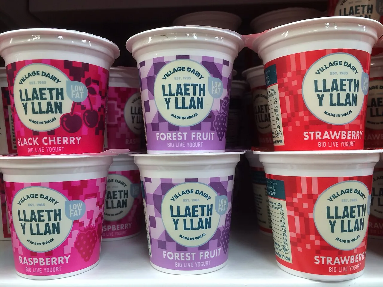 Different branded round dairy tubs with plastic lids